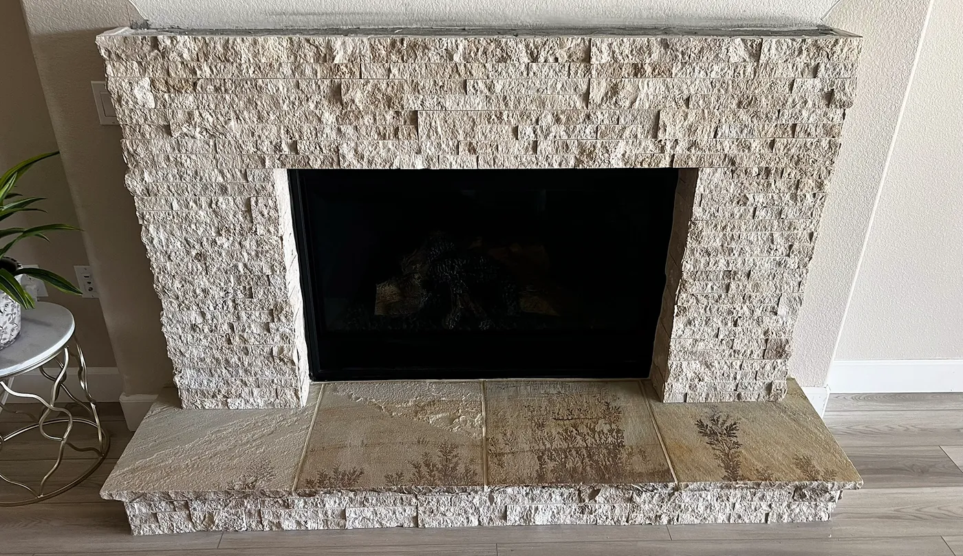 Light split-face stone fireplace surround with a raised stone hearth